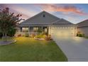 Charming home with a well-manicured lawn, beautiful landscaping, and a two-car garage at 3978 Nottingham Loop, The Villages, FL 32163