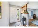 Inviting entryway featuring a decorative door with a glass panel and an accent table at 400 W Washington St, Minneola, FL 34715