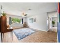 Spacious living room featuring wood-look flooring, ceiling fan, and lots of natural light at 400 W Washington St, Minneola, FL 34715
