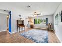 Bright and airy living room with laminate floors, ceiling fan and large window at 400 W Washington St, Minneola, FL 34715