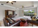 Spacious living room with a sliding glass doors, neutral walls and dark wood furniture at 52 Camino Real Blvd, Howey In The Hills, FL 34737