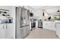 Modern kitchen with stainless steel appliances, white cabinetry, and stylish countertops at 5562 Charleston Avenue, Tavares, FL 32778
