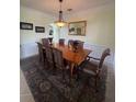 Elegant dining room with wainscoting and decorative chandelier at 633 Grand Cypress Pt, Sanford, FL 32771
