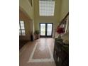 Grand two-story foyer with decorative tile and natural light at 633 Grand Cypress Pt, Sanford, FL 32771
