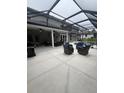 Spacious covered patio featuring a BBQ grill and plenty of seating overlooking the pool and fenced-in backyard at 633 Grand Cypress Pt, Sanford, FL 32771