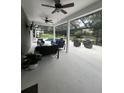 Screened-in lanai with ample seating perfect for entertaining by the pool and waterfall feature at 633 Grand Cypress Pt, Sanford, FL 32771