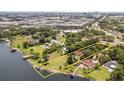 Aerial view of waterfront property showcasing lush landscaping and lake access at 6665 Lake Cane Dr, Orlando, FL 32819
