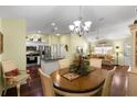 Open concept dining and living area with hardwood floors and stainless steel kitchen appliances at 891 Lucky Ln, The Villages, FL 32162