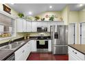 This kitchen showcases modern appliances, white cabinetry, and an efficient layout at 891 Lucky Ln, The Villages, FL 32162