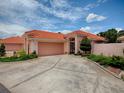 Charming one-story home featuring a red tile roof, spacious driveway, and well-maintained landscaping at 903 Santa Anna Ln, Lady Lake, FL 32159