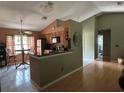 Open kitchen with modern appliances, a breakfast bar, and ample natural light at 9375 Woodbreeze Blvd, Windermere, FL 34786