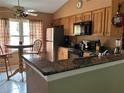 Cozy kitchen with breakfast nook, stainless steel refrigerator, and granite counters at 9375 Woodbreeze Blvd, Windermere, FL 34786