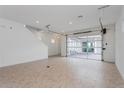 Large garage space with tile flooring and a glass panel garage door, leading to the home's interior at 9670 Rodbell St, Orlando, FL 32827