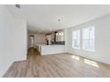 Bright living room with seamless flow into the kitchen, boasting hard surface floors, bright lighting, and ample space at 10061 Dulbecco St, Orlando, FL 32827