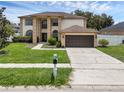 Beautiful two-story home with a two-car garage and a landscaped front yard at 1109 Needlewood Loop, Oviedo, FL 32765