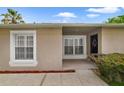 The front of a single Gathering home shows a well-kept lawn and neutral paint at 15169 Harrowgate Way, Winter Garden, FL 34787