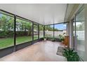Enclosed patio with tile flooring, providing a relaxing outdoor living space at 15169 Harrowgate Way, Winter Garden, FL 34787