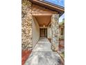 Inviting front porch with stone pillars and a decorative pendant light at 161 Cindy Ct, Lake Mary, FL 32746