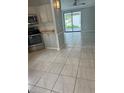 Bright living area with tile flooring and sliding glass doors to the outdoors at 1626 Cypress Pt, Lady Lake, FL 32159