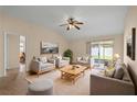 Bright living room features neutral decor, cozy seating, and a sliding glass door to the backyard at 1730 Dorset Dr, Mount Dora, FL 32757