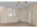 Inviting living room showcasing an open layout, neutral tones, and seamless transition to the adjoining kitchen at 1730 Dorset Dr, Mount Dora, FL 32757