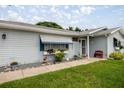 Inviting home exterior featuring a beautifully landscaped yard with flower boxes and a charming front entry at 17533 Se 96Th Ct, Summerfield, FL 34491