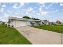 Charming home with a long driveway, well-maintained lawn, and flowerbeds enhancing curb appeal at 17533 Se 96Th Ct, Summerfield, FL 34491