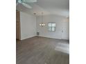 Open living room with vaulted ceilings and wood-look flooring at 1964 Rhett Rd, The Villages, FL 32163