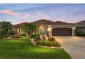 Charming home with lush landscaping, decorative driveway, and a warm, inviting exterior at 219 Carrera Dr, The Villages, FL 32159