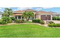 Well-manicured front yard with lush landscaping and charming single-story home at 219 Carrera Dr, The Villages, FL 32159