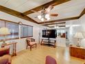 Cozy living room with wood floors, ceiling fan, and stylish furnishings, creating a welcoming atmosphere at 239 Rue De Fontaine, Tavares, FL 32778