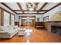 Sophisticated living room featuring a cozy fireplace, coffered ceilings, and detailed woodwork at 263 Ne 1St St, Webster, FL 33597