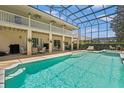 Relaxing screened-in pool with jacuzzi and covered patio for outdoor entertaining at 5144 Rishley Run Way, Mount Dora, FL 32757