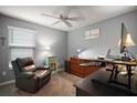 Cozy bedroom designed as a home office with a ceiling fan and relaxing gray color scheme at 6342 Whittle Ct, The Villages, FL 32163