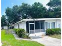 Charming home featuring a screened in porch and well-manicured lawn at 679 Avenue Q Se, Winter Haven, FL 33880