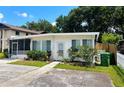 Quaint single-story home with tidy landscaping, an enclosed porch, and inviting front walkway at 679 Avenue Q Se, Winter Haven, FL 33880