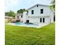 Spacious backyard with a beautiful in-ground pool and a wooden deck at 8203 Bluestar Cir, Orlando, FL 32819