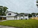 Charming two-story home with a large lawn and a welcoming exterior at 8203 Bluestar Cir, Orlando, FL 32819