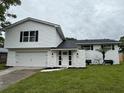 Inviting two-story home with a manicured lawn and a white exterior at 8203 Bluestar Cir, Orlando, FL 32819