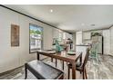 Bright dining area with a wooden table, stylish bench seating, and a view of the kitchen at 892 Se 124Th Ave, Webster, FL 33597