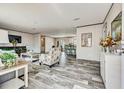 Open-concept living room with stylish decor, modern flooring, and plenty of natural light at 892 Se 124Th Ave, Webster, FL 33597