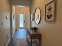 Welcoming foyer with decor, wood-look tile and furniture at 9219 Chandler Dr, Groveland, FL 34736