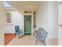 Cozy front porch with seating, offering a welcoming entrance to the home at 9588 Se 124Th Loop, Summerfield, FL 34491