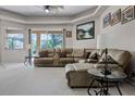 Spacious living room featuring a comfortable sofa, ceiling fan, and view of the outdoors at 965 Dartmouth Ave, Clermont, FL 34711