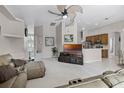 Open-concept living room flows seamlessly to kitchen; great for entertaining at 965 Dartmouth Ave, Clermont, FL 34711