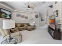 Cozy living room with comfortable seating, soft carpet and TV at 965 Dartmouth Ave, Clermont, FL 34711