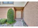 Inviting front entrance with brick pathway and well maintained landscaping leading to a stylish door at 102 Lake Emma Cove Dr # 102, Lake Mary, FL 32746