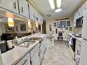 Well-lit kitchen with vintage cabinetry, modern appliances, and easy access to living area at 105 Avocado Cv, Leesburg, FL 34748