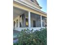 Classic home featuring a screened front porch with charming architectural columns at 110 S Trowell Ave, Umatilla, FL 32784