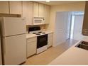 Bright kitchen with white appliances and tile flooring at 1108 Apple Ter, Leesburg, FL 34748